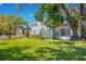 Beautiful home featuring a well-manicured lawn, mature trees, and a relaxing swing at 809 E Ridgewood St, Orlando, FL 32803