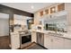 Bright kitchen with stainless steel appliances, white cabinets, marble countertops, and a view to the patio at 809 E Ridgewood St, Orlando, FL 32803