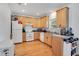 Efficient kitchen features light wood cabinets, matching appliances, and laminate countertops at 809 E Ridgewood St, Orlando, FL 32803