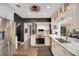 Modern kitchen with stainless steel appliances, white cabinets, marble countertops, and hardwood floors at 809 E Ridgewood St, Orlando, FL 32803