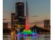 Night view of Lake Eola's iconic fountain illuminated with colorful lights, surrounded by the downtown Orlando skyline at 809 E Ridgewood St, Orlando, FL 32803