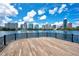 Panoramic lake view with an inviting wood deck overlooking the downtown Orlando skyline under a bright blue sky at 809 E Ridgewood St, Orlando, FL 32803