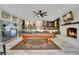 Open floor plan with living room, pool table, fireplace, adjacent kitchen, and access to outdoor patio at 809 E Ridgewood St, Orlando, FL 32803