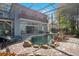 Beautiful backyard pool area with a stone waterfall feature, lounging chairs, and a screened-in enclosure at 809 E Ridgewood St, Orlando, FL 32803