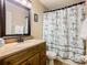 Bathroom featuring granite vanity, framed mirror, and anchor print shower curtain at 215 Riggs Cir, Davenport, FL 33897