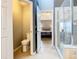 View of the bathroom leading to a bedroom and enclosed shower with glass doors at 215 Riggs Cir, Davenport, FL 33897
