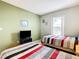 Light and bright bedroom with neutral paint, two beds and a large window overlooking pool at 215 Riggs Cir, Davenport, FL 33897