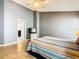 Bedroom featuring a ceiling fan, tile floor, and television, with a doorway to the bathroom at 215 Riggs Cir, Davenport, FL 33897