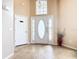 Bright foyer with tile floors, front door with sidelights and transom, and a closet at 215 Riggs Cir, Davenport, FL 33897
