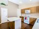 Kitchen featuring modern appliances, white countertops, and laminate flooring at 215 Riggs Cir, Davenport, FL 33897