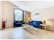 Bright living room featuring high ceilings, a large window, tile flooring, and modern decor at 215 Riggs Cir, Davenport, FL 33897
