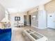 Spacious living room with an open concept to dining area and bright neutral paint at 215 Riggs Cir, Davenport, FL 33897