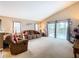 Inviting living room features a vaulted ceiling, neutral colors, and sliding glass doors to the pool area at 215 Riggs Cir, Davenport, FL 33897