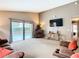 Comfortable living room features neutral paint and sliding glass doors to the screened-in pool area at 215 Riggs Cir, Davenport, FL 33897