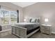 Serene bedroom with a queen bed, soft lighting, and a view of the neighborhood at 4243 Paragraph Dr, Kissimmee, FL 34746