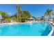 Refreshing community pool surrounded by lush greenery and comfortable seating at 4243 Paragraph Dr, Kissimmee, FL 34746