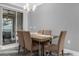 Cozy dining room with stylish chandelier, seating for four, and sliding door to a patio at 4243 Paragraph Dr, Kissimmee, FL 34746