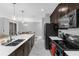 Modern kitchen featuring stainless steel appliances, dark wood cabinetry, and spacious countertops at 4243 Paragraph Dr, Kissimmee, FL 34746
