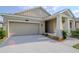 Charming single-story home featuring a two-car garage, covered porch with columns, and well-maintained landscaping at 5315 Amersham Ln, St Cloud, FL 34771