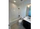 Bathroom with a bathtub, toilet and dark vanity at 2018 Packing District Way, Orlando, FL 32804