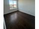Spacious bedroom with dark hardwood floors and a view at 2018 Packing District Way, Orlando, FL 32804
