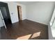 Bright bedroom featuring dark hardwood floors and large window at 2018 Packing District Way, Orlando, FL 32804
