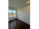 Bright bedroom with dark hardwood floors and large window at 2018 Packing District Way, Orlando, FL 32804