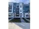Modern townhouses with gray and white exterior, landscaping, and walkways at 2018 Packing District Way, Orlando, FL 32804
