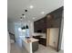 Modern kitchen with dark cabinets, quartz countertops, and island at 2018 Packing District Way, Orlando, FL 32804