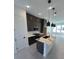 Modern kitchen with dark cabinets, quartz countertops, and island at 2018 Packing District Way, Orlando, FL 32804