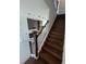 Modern staircase with dark wood treads and black metal railing at 2018 Packing District Way, Orlando, FL 32804