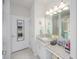 Bright bathroom featuring granite countertops, large mirror, and vanity area at 745 Asturias Rd, Davenport, FL 33837