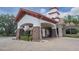 The entry to a large clubhouse with tall white pillars and a red brick facade at 745 Asturias Rd, Davenport, FL 33837