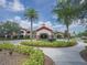 Exterior of the clubhouse and circular driveway with manicured landscaping at 745 Asturias Rd, Davenport, FL 33837