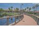 View of a clubhouse overlooking a lake, with a bridge extending over the water at 745 Asturias Rd, Davenport, FL 33837