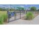 Community dog park featuring shade and play areas, secured by a tall metal fence at 745 Asturias Rd, Davenport, FL 33837