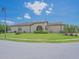 Well-maintained home with a spacious front yard, complemented by mature trees and green landscaping at 745 Asturias Rd, Davenport, FL 33837