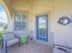 Charming front porch with comfortable seating, offering a welcoming entrance with a decorative door at 745 Asturias Rd, Davenport, FL 33837
