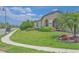 Home showcasing a lush green lawn and landscaped garden beds with a variety of colorful plants and shrubs at 745 Asturias Rd, Davenport, FL 33837