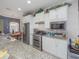 Bright kitchen with stainless steel appliances, granite countertops, and white cabinetry at 745 Asturias Rd, Davenport, FL 33837