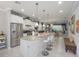 Spacious kitchen with a granite island, stainless steel appliances, and seamless flow into the living area at 745 Asturias Rd, Davenport, FL 33837