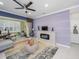 Open living room features modern fireplace, tiled floors, and lots of natural light at 745 Asturias Rd, Davenport, FL 33837