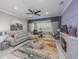 Spacious living room featuring tile floors, modern decor, and a cozy fireplace at 745 Asturias Rd, Davenport, FL 33837