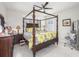 The main bedroom features a four-poster bed, plantation shutters and ceiling fan at 745 Asturias Rd, Davenport, FL 33837