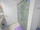 Bathroom features a glass-enclosed shower and linen storage at 745 Asturias Rd, Davenport, FL 33837