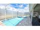 Sparkling screened pool with hot tub, surrounded by brick pavers and bathed in sunlight at 8834 Cabot Cliffs Dr, Davenport, FL 33896