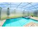 Enclosed pool and hot tub featuring clear blue water and privacy screens, offering a serene retreat at 8834 Cabot Cliffs Dr, Davenport, FL 33896