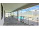 Covered outdoor patio with a swimming pool and connected hot tub, fenced for safety, and a dining area nearby at 8834 Cabot Cliffs Dr, Davenport, FL 33896