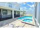 Beautiful backyard featuring a swimming pool and hot tub inside a screened enclosure and a brick paver deck at 8834 Cabot Cliffs Dr, Davenport, FL 33896