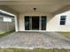 Covered patio with pavers and sliding glass doors at 4922 Shady Pines Dr, Saint Cloud, FL 34772